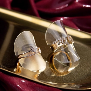 Minimalist ring display stands with rose gold butterfly ring and wide zircon gold band