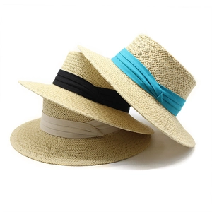 Trio of classic boater straw hats with black, beige, and blue ribbons for summer sun protection