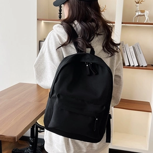 Minimalist black solid color large capacity backpack with front zipper pocket for women