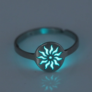 Detailed view of luminous stainless steel ring with hollow star pattern glowing in dark