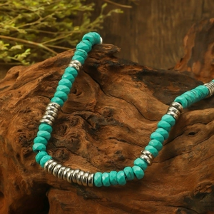 Bohemian vintage necklace with turquoise stones and silver metal beads on wood
