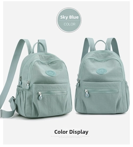Water blue nylon backpack featuring side elastic pockets and silver metal zippers detail