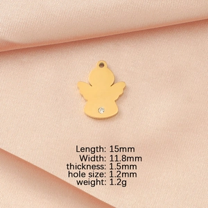 Detailed size view of a gold angel pendant with measurements on pink satin fabric