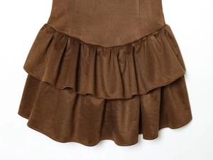 Détail de l'ourlet à volants superposés en daim marron avec texture de qualité