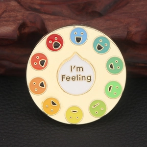 Close-up of a circular enamel mood spinner pin featuring ten colorful emotion icons