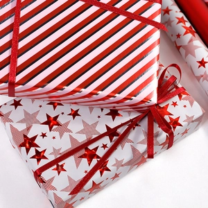 Christmas gift wrapping paper set with red stripes and stars patterns and silk ribbon
