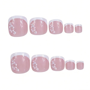 Detail view of glossy square toe press-on nails with white French tips and flower patterns