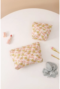 Detail of floral embroidered mesh cosmetic bags showing intricate stitching and zipper closure