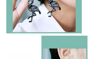 Detailed view of novelty acrylic flamingo skeleton drop earrings for Halloween