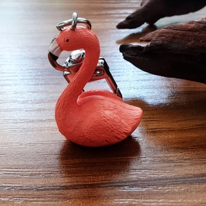Close-up of pink flamingo keychain with detailed feather texture and silver metal clasp