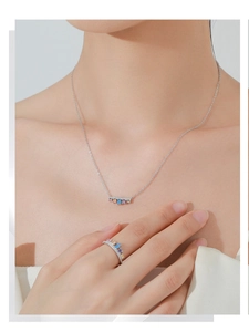 Detail view of silver S925 necklace and ring set with colorful square-cut zircons