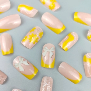 Floral yellow and pink press-on nails set with 3D bows and glittery accents