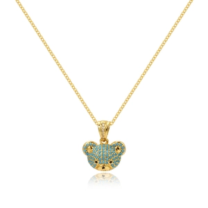 Detailed close-up of golden bear pendant with turquoise stones and diamond accents on chain
