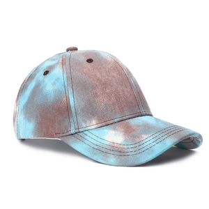 Detail of blue and brown tie-dye baseball cap with 6-panel structure and curved brim