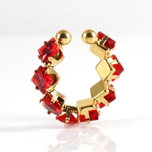 Macro detail of gold-plated ear cuff with pavé red square-cut cubic zirconia stones