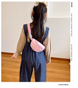 Rear view of a child wearing a pink quilted PU leather chest bag with adjustable strap