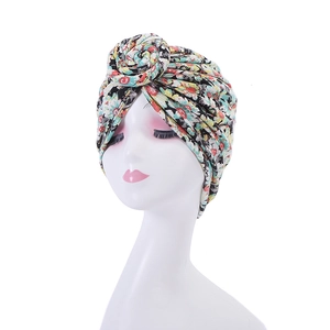 Detail of floral printed headscarf turban with knot design on white mannequin head