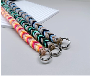 Detail of three colorful handmade braided paracord straps with silver metal ring buckles