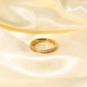 Elegant gold titanium steel ring with channel-set square zircons on silk background