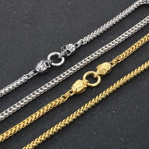 Punk style stainless steel double skull necklaces in silver and gold finishes