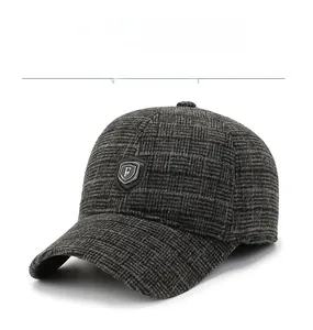 Detail of grey wool blend baseball cap showing thick tweed texture and metal shield logo