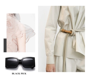 Detail of square black bold frame sunglasses with dark lenses and fashion apparel