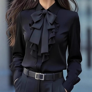 Elegant black long sleeve satin shirt featuring oversized bow and ruffle collar detail