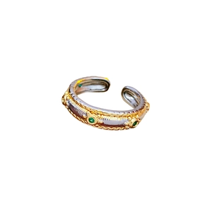 Vintage oval open ring featuring dual-tone silver and gold metal with green gemstone