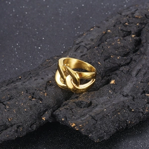 Macro view of gold chain link ring for men on charcoal with celestial backdrop
