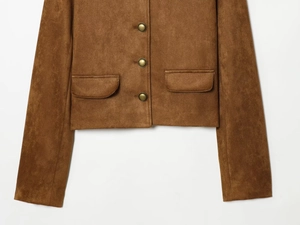 Detail of brown faux suede jacket featuring bronze buttons and symmetrical flap pockets