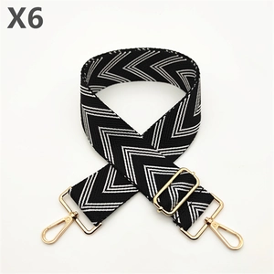 Detail of black and white chevron fabric strap with golden metal hooks and adjustment buckle