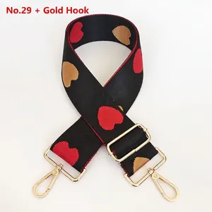 Detail of thickened jacquard nylon strap with red heart patterns and gold metal hooks