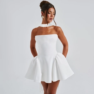Detail of white strapless mini dress featuring a pleated skirt and matching neck accessory