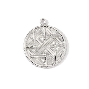 Detailed view of a silver stainless steel round pendant with textured geometric pattern