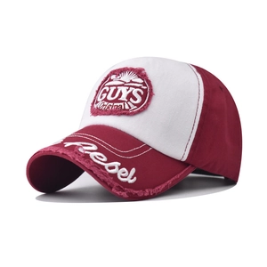 Macro shot of GUYS Original embroidery and Rebel lettering on distressed baseball cap