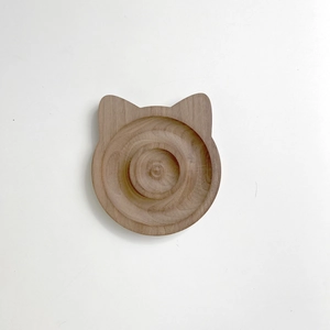 Detail shot of cat-ear shaped walnut wood jewelry tray showing natural grain texture