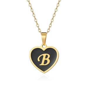Detailed view of a gold heart pendant with black enamel and gold cursive letter B