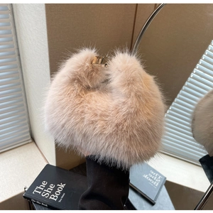 Close-up of fluffy faux fur handbag with elegant gold metal clasp and soft texture