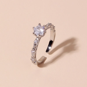 Macro shot of adjustable silver ring with center crystal and textured cubic zirconia band