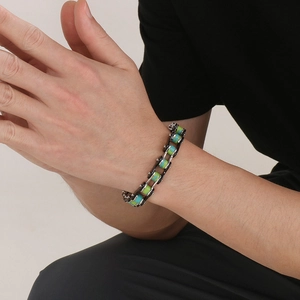 Men's silver stainless steel bike chain bracelet with turquoise stone inlays on wrist