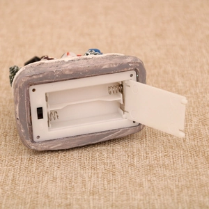 Detail of resin Christmas ornament base with battery compartment and on-off switch