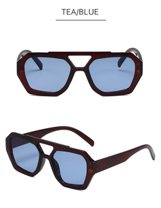 Detail of double bridge irregular sunglasses in tea red frame with blue tinted lenses