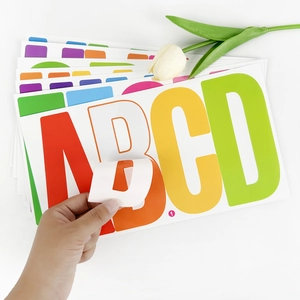 Hand peeling a 6-inch colorful waterproof vinyl letter sticker for outdoor car and boat use