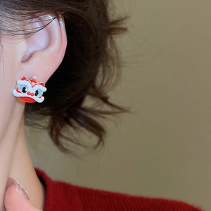 Close-up of a red lion dance stud earring with pearl detail on a female model