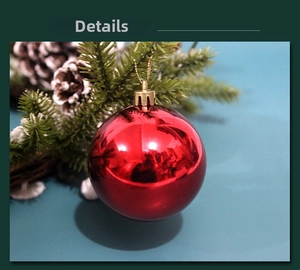 Close-up of shiny red Christmas ball ornament with golden cap and hanging string