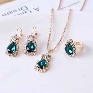 Detail of bridal jewelry set with emerald green teardrops and pavé crystals