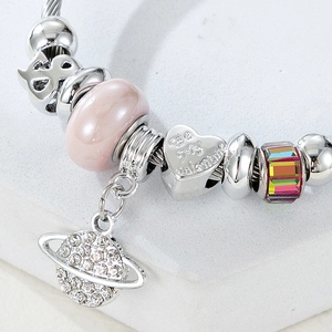 Close-up of silver snake chain with pink marble bead and heart valentine pendant