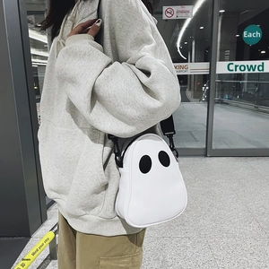 Detail showing the adjustable black strap and white PU ghost bag on a fashion model