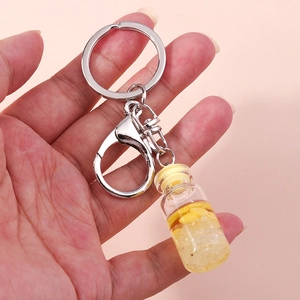 Detailed view of a mini glass bottle keychain with artificial lemon slices and ice sugar
