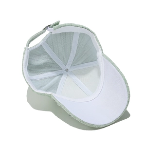 Detail view of the light green baseball cap showing inner lining and stitching